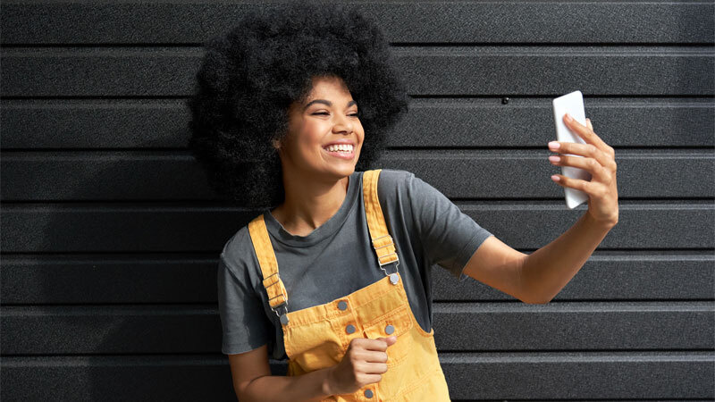 Alphabet Tik Tok Woman Holding Phone Brick Wall