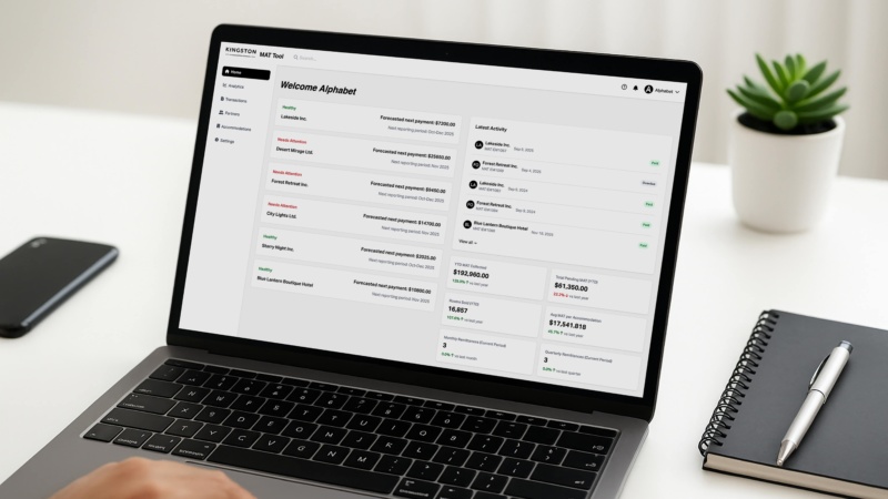 Laptop on a desk displaying the Kingston MAT Tool dashboard, showing accommodation statuses, recent reporting activity, and year-to-date municipal accommodation tax metrics.