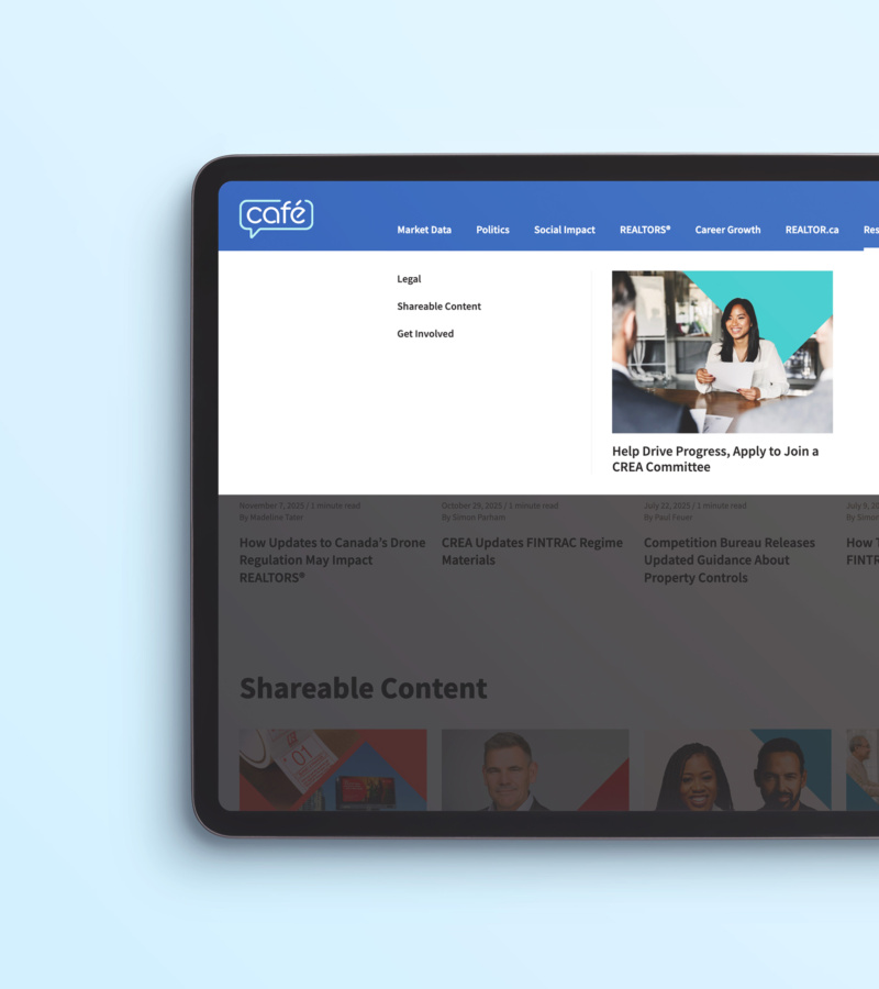 Close-up of a tablet displaying the CREA Café website’s blue navigation bar and dropdown menu, with a featured article thumbnail showing a smiling woman in a white blazer.