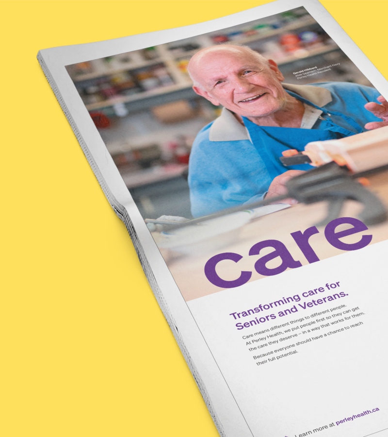 Newspaper ad showing senior man in workshop with text “Transforming care for Seniors and Veterans.”
