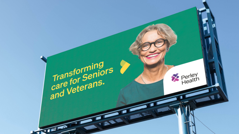 Outdoor billboard with smiling woman and text “Transforming care for Seniors and Veterans” beside Perley Health logo.
