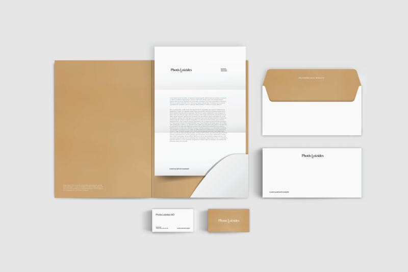 Branded stationery set with folder, letterhead, envelope and business cards in white and gold.