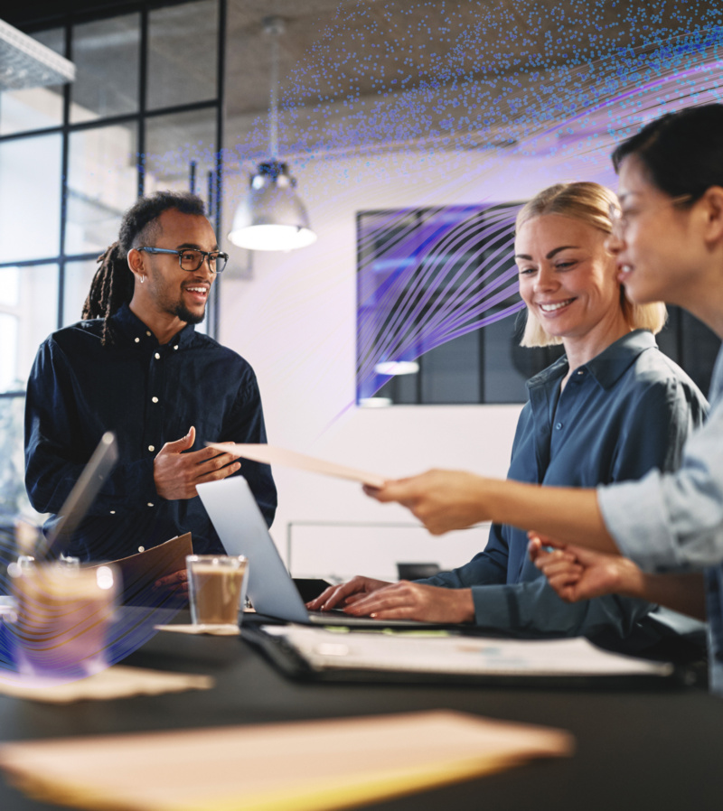 Three colleagues collaborate in an office, with abstract digital waves overlaid.