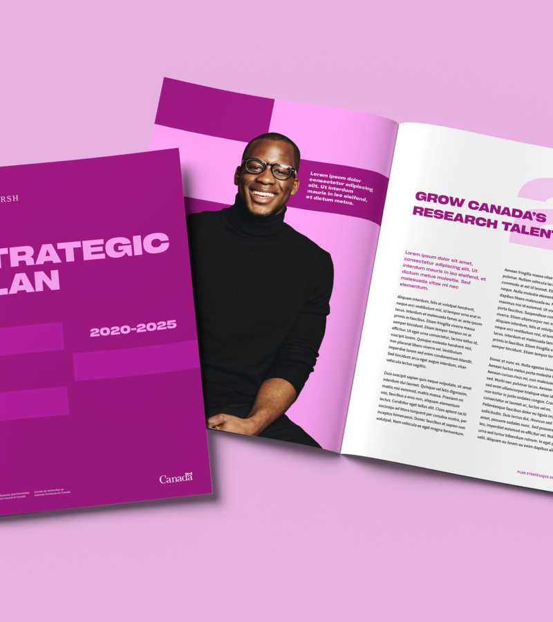 Strategic plan booklet open on pink background, featuring man in black turtleneck.