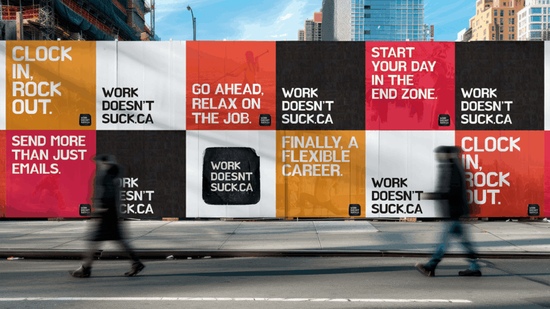 Street-level billboard hoarding covered with bold text ads in red, orange, white, and black panels promoting WorkDoesntSuck.ca, with slogans like ‘Clock in, rock out,’ ‘Go ahead, relax on the job,’ and ‘Finally, a flexible career,’ while two blurred pedestrians walk past.
