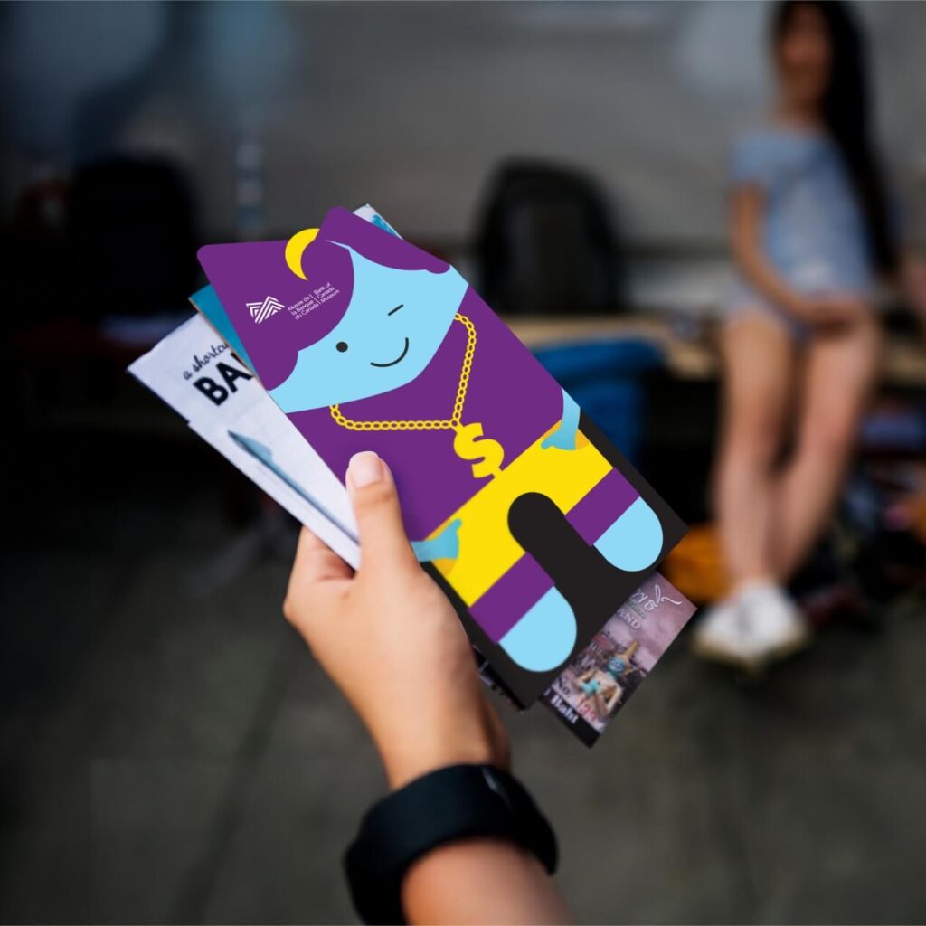brochure held in the hand of a museum goer